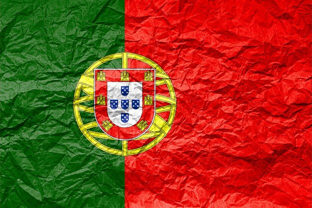 Photo flag of portugal on crumpled paper textured background