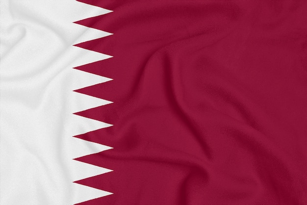 Flag of Qatar on textured fabric.