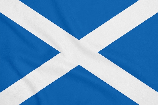 Photo flag of scotland on soft and smooth silk texture. national symbol of scotland.