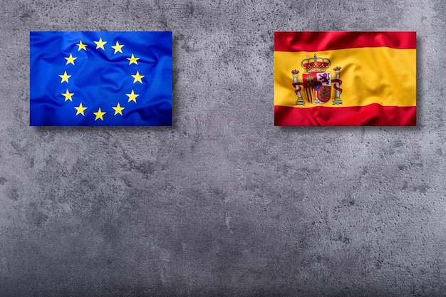 Flag of Spain and European Union on concrete background.