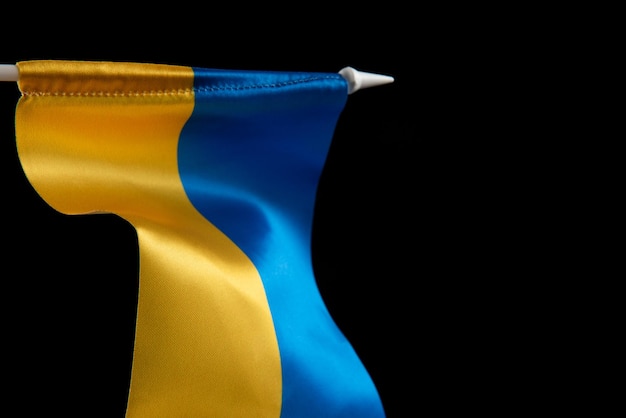 Flag of ukraine on dark background is developing in the wind yellow and blue the colors of the natio