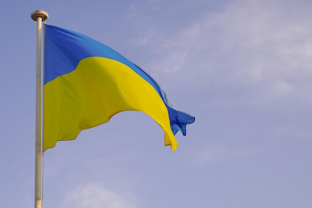 Flag ukrainian National state flag of Ukraine in yellow blue banner on cloudy sky