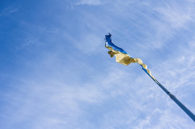 Flagpole with the Ukrainian flag against blue sky