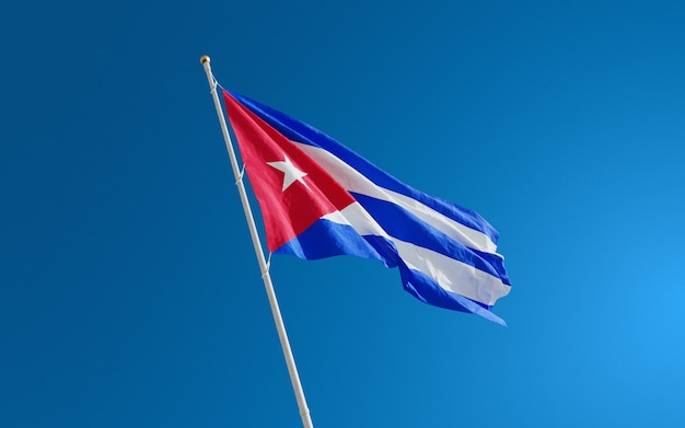 Flags of Cuba isolated close-up on blue sky background