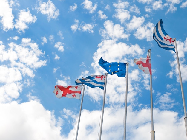 Flags of Georgia, Adjara and the European Union on blue sky