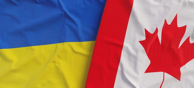 Flags of Ukraine and Canada Linen flags close up Flag made of canvas Ukrainian Canadian Ottawa National symbols 3d illustration