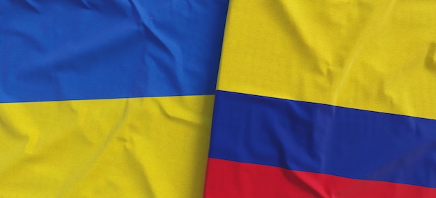 Flags of Ukraine and Colombia Linen flag closeup Flag made of canvas Ukrainian Kyiv Bogota South America National symbols 3d illustration