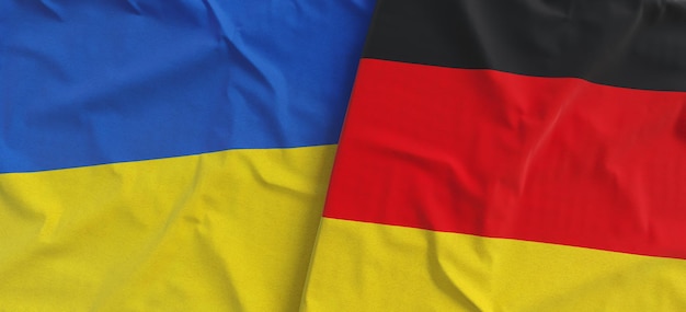 Flags of Ukraine and Germany Linen flag close up Flag made of canvas Ukrainian German Berlin National symbols 3d illustration