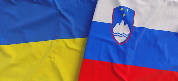 Flags of Ukraine and Slovenia Linen flags close up Flag made of canvas Ukrainian Slovenian Ljubljana National symbols 3d illustration