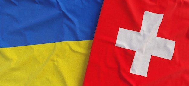 Flags of Ukraine and Switzerland Linen flags close up Flag made of canvas Ukrainian Swiss National symbols 3d illustration