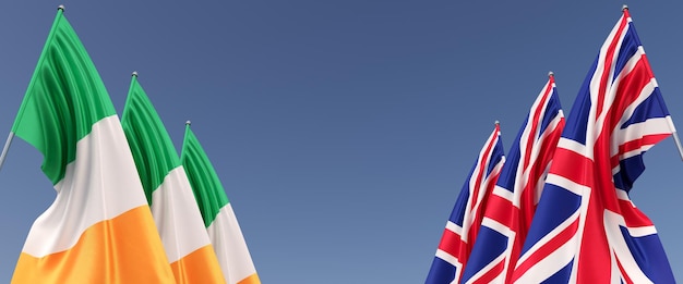 Flags of the United Kingdom and Ireland on flagpoles on sides Six flags on a blue background Place for text Great Britain England Dublin 3D illustration