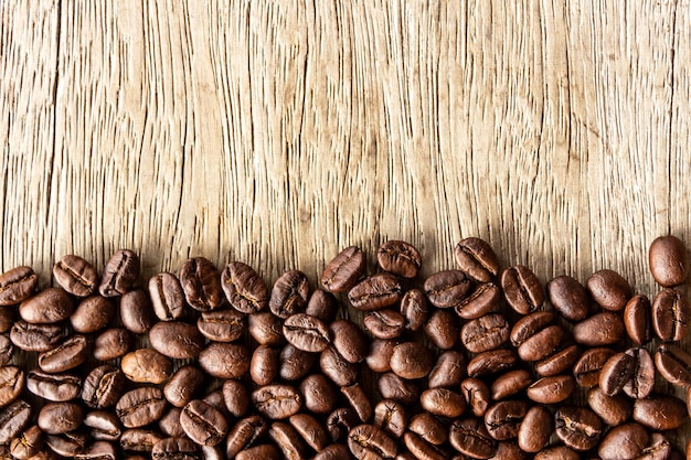 Flame with Coffee beans on old wood background