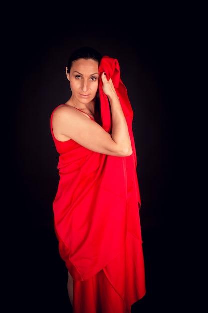 Flamenco woman in red dress and picking up dress