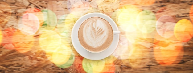 Photo flare above and coffee on a table at a cafe for breakfast lunch or morning energy at a restaurant drink diner and latte espresso or cappuccino at a coffee shop for peace calm and caffeine