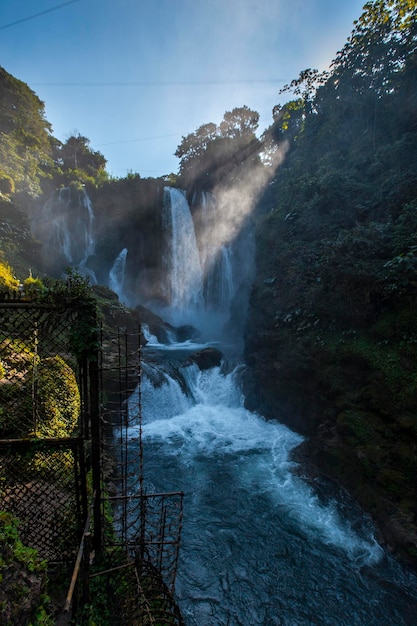 Flashes of the sun at dawn inside the Pulhapanzak waterfall on Lake Yojoa Honduras