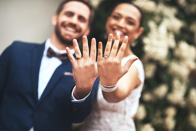 Flashing our symbols of love Shot of a happy newlywed young couple showing their rings on their wedding day