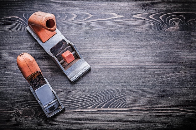 Flat hand shaving vintage planes on wooden board