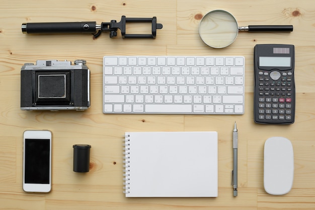 Flat lay of accessories on wooden desk background