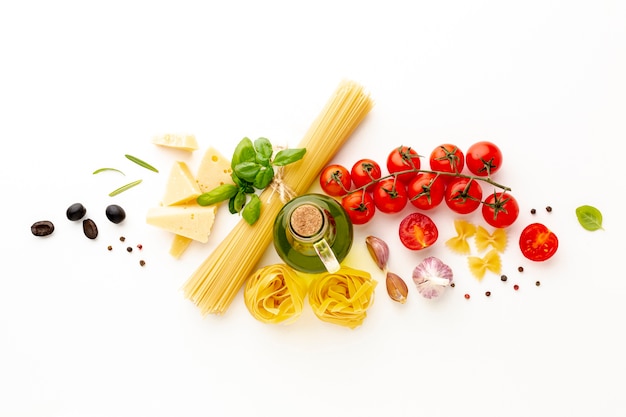 Flat lay arrangement of uncooked pasta and ingredients