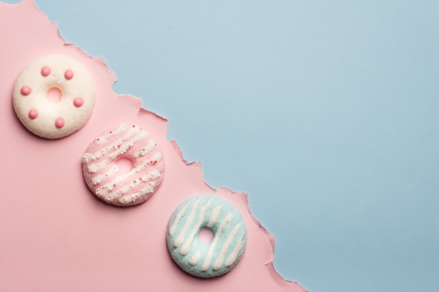 Flat lay of assortment of glazed doughnuts with copy space