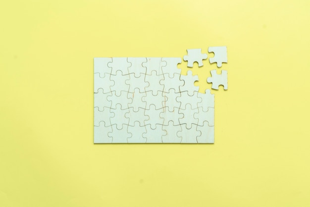 A flat lay of blank puzzle jigsaw, solution and desiciion making concept