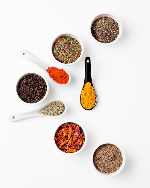 Flat lay bowls and spoons with spices