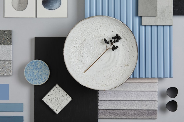 Photo flat lay composition of stylish architect moodboard with samples of textile paint blue wooden lamella panels and tiles white black blue and light grey color palette copy space template