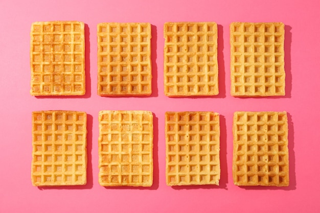 Flat lay composition with belgian waffles on color table