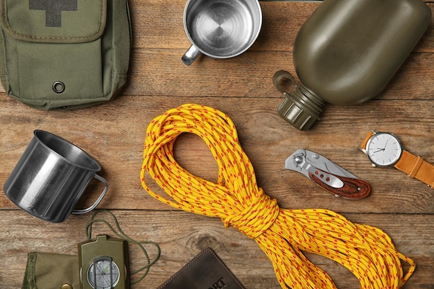 Photo flat lay composition with camping equipment on wooden background