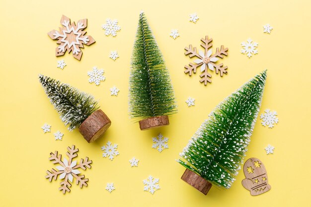 Flat lay composition with christmas trees on color background. Top view with copy space