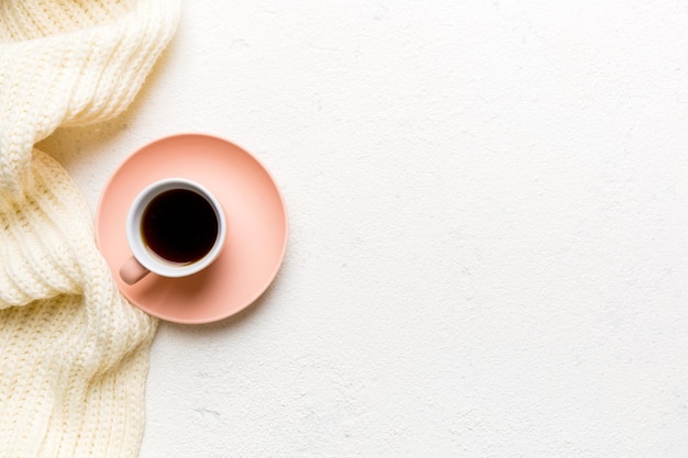 Flat lay composition with colorful Autumn cup of coffee and leaves on a color background top view