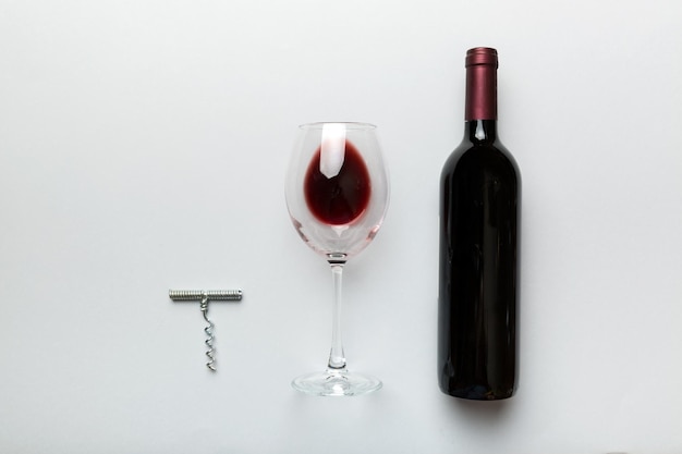 Flat lay composition with corkscrew bottle of wine and elegant glass on colored table Flat lay top view wth copy space