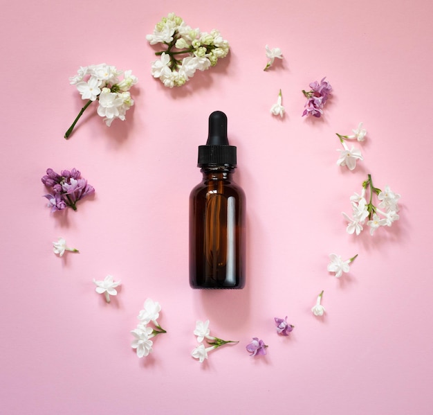 flat lay composition with cosmetic items and lilac flowers on a pink delicate background Mothers da