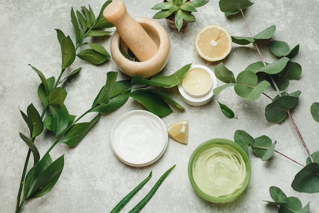 Flat lay composition with cosmetic products. Natural organic botany , Alternative herb medicine, Natural skin care beauty products. The creation of natural cosmetics in a mortar of