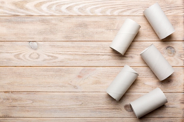 Flat lay composition with empty toilet paper rolls and space for text on color background Recyclable paper tube with metal plug end made of kraft paper or cardboard