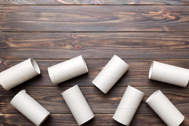 Flat lay composition with empty toilet paper rolls and space for text on color background Recyclable paper tube with metal plug end made of kraft paper or cardboard