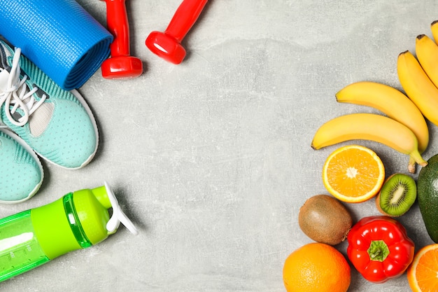 Flat lay composition with healthy lifestyle accessories on grey background