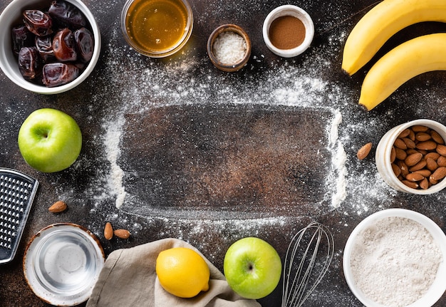 Flat lay composition with ingredients for vegan baking on dark background