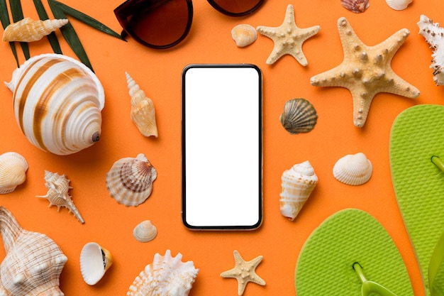 Flat lay composition with Phone and beach accessories on colored background Smartphone with blank screen mock up with copy space