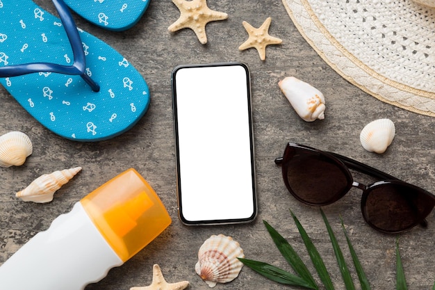 Flat lay composition with Phone and beach accessories on colored background Smartphone with blank screen mock up with copy space