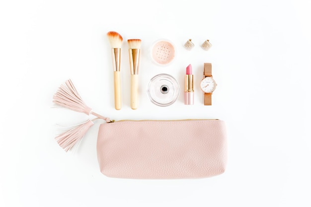 Flat lay composition with pink cosmetic bag with cosmetic makeup products isolated on white backgrou