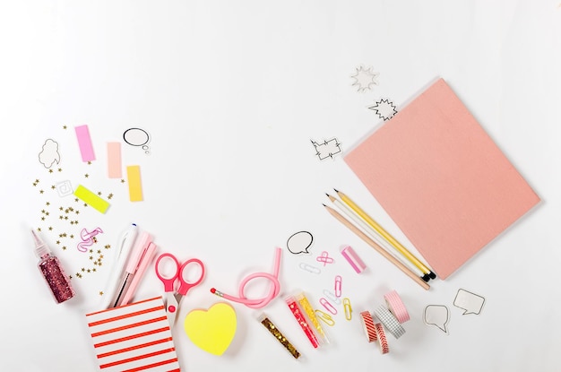 Flat lay composition with pink school supplies on white background