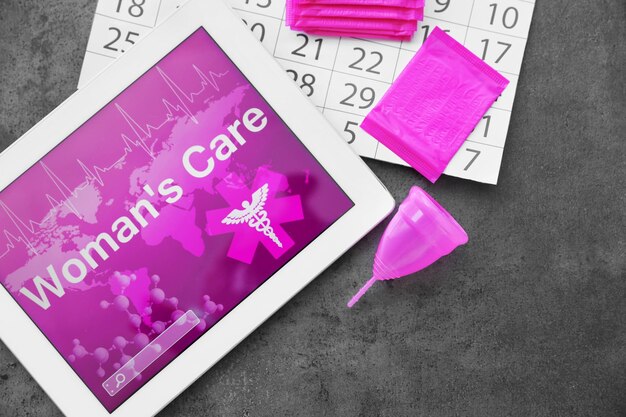 Photo flat lay composition with tablet calendar and feminine hygiene items on grey background gynecological care