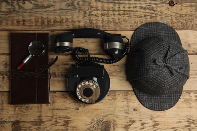 Flat lay composition with vintage detective items on wooden table