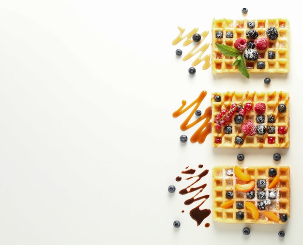 Flat lay composition with waffles and different toppings