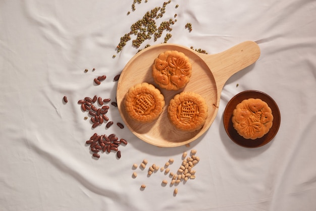 Flat lay conceptual of Mid-autumn Festival food mooncake. Text on cake mean Happiness.