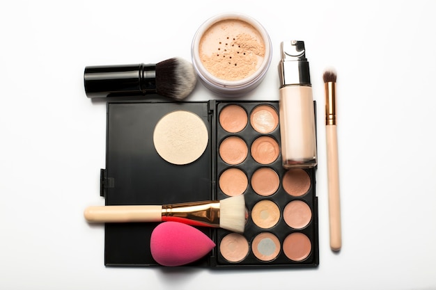 Flat lay of contouring palette,makeup brushes and mineral powder on a white background