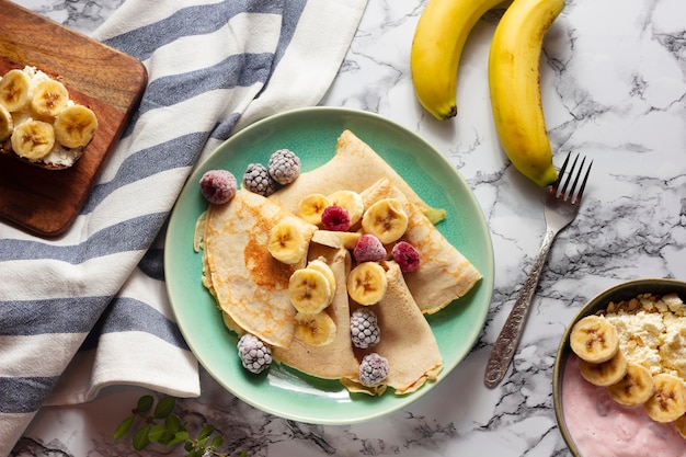 Flat lay crepes with mix of fruits