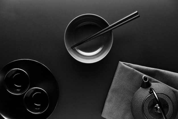 Flat lay of crockery with teapot and chopsticks