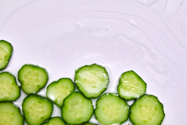 Flat lay cucumber slices with gel on white background